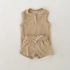 Get ready for summer with our Delta Terry Set! This versatile and comfortable set includes a terry sleeveless top and drawstring shorts. Perfect for both boys and girls, as well as babies and toddlers. Stay cool and stylish all summer long. Summer Beige Playwear Sets, Beige Playwear Sets For Summer, Casual Beige Playwear Sets, Sleeveless Short Set For Summer Loungewear, Beige Tops For Summer Playwear, Sleeveless Summer Short Set, Summer Playwear Short Set, Sleeveless Summer Short Set For Beach, Beige Sleeveless Sets For Vacation