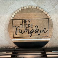 a wooden sign that says hey there pumpkin on the front of a stove top oven