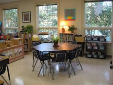 a room with several tables and chairs in it