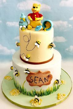 a winnie the pooh birthday cake with bees on it