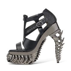 a high heeled sandal with spikes on the side and an open toe design