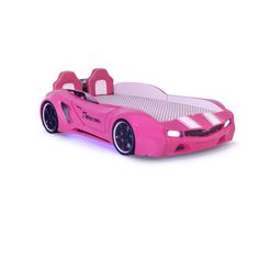 a pink toy car that is sitting on a white surface with its wheels turned to the side