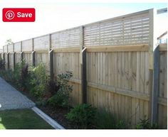 a long wooden fence next to a green lawn