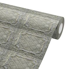 a roll of decorative wallpaper with an intricate design on the front and back side