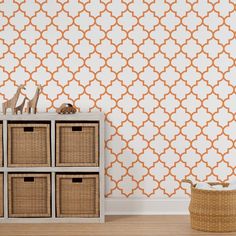 an orange and white wallpaper with baskets on the floor