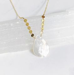 This is the perfect summer necklace! It’s features a white mother of pearl teardrop pendant that dangles between a row of 14kt gold filled tiny disks.  The chain is 14kt gold filled fine cable. The necklace is 17” and is finished with a spring ring clasp in my signature large end ring. Minimalist Teardrop Drop Necklace With Pearl Charm, White Dangle Drop Necklace With Adjustable Chain, White Drop Necklace With Delicate Chain, Minimalist Teardrop Pearl Chain Drop Necklace, Teardrop Pearl Charm Necklace In 14k Gold Filled, 14k Gold-filled Teardrop Pearl Pendant Necklace, 14k Gold Filled Teardrop Necklace With Pearl Charm, Teardrop Pearl Pendant Necklace In 14k Gold Filled, 14k Gold-filled Teardrop Necklace With Pearl Charm