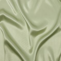 an image of a plain light green fabric textured with satine or polyester