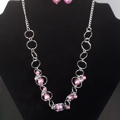 Silver With Purple Necklace And Purple Earrings Silver Sterling Silver Jewelry Sets For Party, Pink Metal Jewelry With Adjustable Chain, Wire Wrapped Round Jewelry For Parties, Wire Wrapped Jewelry For Parties, Pink Sterling Silver Jewelry For Party, Elegant Silver Nickel-free Jewelry Sets, Elegant Nickel-free Pink Jewelry, Silver Jewelry Sets With Adjustable Chain For Party, Silver Wire Wrapped Costume Jewelry