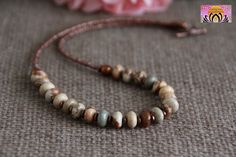 "JASPER NECKLACE          This necklace is composed of Natural Jasper. The tones are natural, earthly, soft, with a blend of beige brown and copper. Easy to close with a convenient toggle clasp. More JASPER jewellery here: https://www.etsy.com/au/shop/ChandraMalaJewellery?ref=seller-platform-mcnav&search_query=jasper MATCHING JASPER BRACELET HERE: https://www.etsy.com/au/listing/744346730/brown-jasper-bracelet-harmonyno?click_key=8abbd47d00d7da8b3725d436c23a35aa2467747b%3A744346730&click_sum=974 Bohemian Beige Jewelry For Meditation, Bohemian Beige Beaded Necklaces With Natural Stones, Adjustable Earthy Necklace For Everyday Wear, Artisan Adjustable Beige Necklace, Artisan Necklace With Natural Variations And Adjustable Fit, Earthy Adjustable Beaded Necklace With Round Beads, Adjustable Hand-strung Nature-inspired Beaded Necklaces, Bohemian Single Strand Necklace For Everyday, Bohemian Beige Necklace For Gift