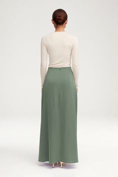 Indulge in timeless elegance with our Essential Satin Maxi Skirt in Sage. Crafted from delicate satin in a classic a-line silhouette, this skirt exudes luxury and can effortlessly elevate any outfit. Perfect for any occasion, this must-have piece will become a staple in your wardrobe. Model is 5'7" and is wearing a size XS. Veiled Collection, Satin Maxi Skirt, Jersey Hijab, Satin Maxi, Satin Skirt, Veil, Beautiful People, Timeless Elegance, Maxi Skirt