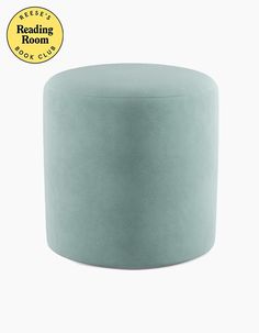 a light blue round stool with a yellow label reading reading room