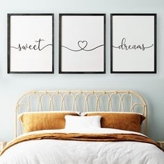 two prints on the wall above a bed