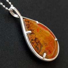 "This elegant and intricately designed necklace features a 25mm x 19mm tear drop form cut Chinese Zhanguo Warring States Red Plume Agate cabochon, a very vivid stone with vibrant and distinctive color. Beautiful plume on both sides, and you can wear reversible. Zhanguo Warring States Red Plume Agate cabochon measures in inch: 1.47\" x 1.1\" Zhanguo Warring States Red Plume Agate cabochon measures in mm: 37mm x 27mm Agate origin: China Pendant measures in inch: 1.90 inch long and 1.14 inch wide a Formal Teardrop Cabochon Necklace, Teardrop Large Pendant Jewelry As Gift, Teardrop Large Pendant Jewelry Gift, Teardrop Large Pendant Jewelry For Gifts, Amber Teardrop Cabochon Necklace, Teardrop Natural Stones Necklace For Gift, Formal Orange Cabochon Necklace, Polished Teardrop Amber Necklace, Red Teardrop Gemstone Drop Necklace