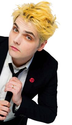 a young man with blonde hair wearing a suit and tie