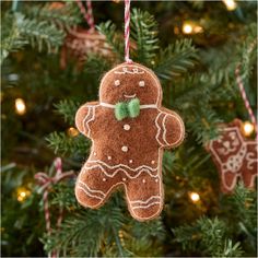 a gingerbread ornament hanging from a christmas tree