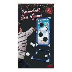 a young boy is playing with the snowball toss game in front of a black background