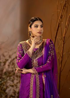 Introducing our stunning Purple Organza Outfit! This elegant dress is adorned with intricate details, featuring beautiful embroidery and embellishments. The rich purple color adds a regal touch, and it comes with a chooridar pajama for a complete look. Perfect for making a statement at special occasions! Elegant Semi-stitched Purple Sets, Semi-stitched Purple Sharara With Resham Embroidery, Semi-stitched Purple Anarkali Unstitched Suit, Elegant Purple Kurta With Mirror Work, Embroidered Purple Sets For Eid, Elegant Purple Sets With Mirror Work, Purple Chinon Salwar Kameez With Dabka Work, Dola Silk Churidar With Dabka For Designer Wear, Designer Dola Silk Churidar With Dabka