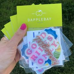 a person holding up some stickers in their hand with the words dapple bay on them