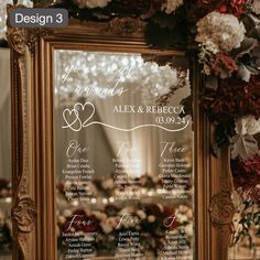 a wedding seating plan is displayed in front of a mirror with flowers on the side