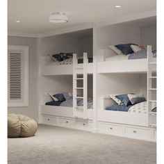 a bedroom with bunk beds and white furniture