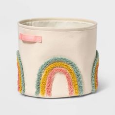 a white pot with a rainbow design on it