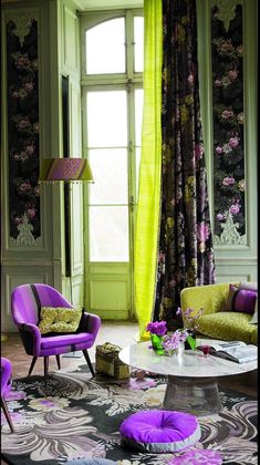 a living room with purple and green furniture