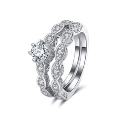 a white gold wedding ring set with an intricate design and round brilliant diamond center stone