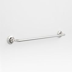 an image of a metal towel bar on the wall with two balls attached to it