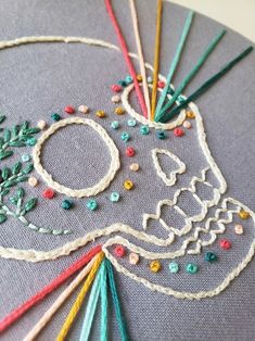 the embroidery design is made with beads and thread