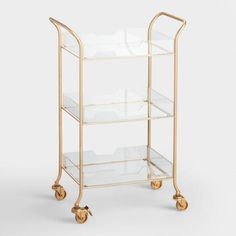 a gold trolley with three shelves on wheels