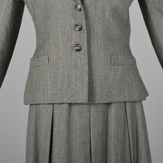 "This listing is for one skirt and jacket suit. The textile is unmarked but feels like wool. This is a smart gray suit in a mid-weight flecked fabric. The jacket has a straight hem, a slant chest pocket, narrow lapels, and two vent pockets. The skirt has nice box pleats and hits at the knee. Padded shoulders on the jacket for structure and presence. Pieces worn together or separately provide many of-the-moment looks. Condition Details: Very good: Small repair at top of front center pleat. Label Classic Tailored Wool Skirt Suit, Classic Winter Skirt Suit For Career, Grey Skirt Suit, Lake Junaluska, Skirt And Jacket, Womens Suits, Jacket Suit, Bill Blass, Gray Suit