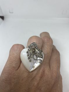 Vintage Mother of Pearl 925 Sterling Silver Marcasite Ring Mother of Pearl set in 925 Sterling Silver Marcasite ring I have size 6.25 Can be re sized for you, my jeweler would charge $10-$20 All rings are shipped in a nice gift box. Check out our over a THOUSAND great reviews Engraving is $4 per letter and is not always perfect depending on the piece. It can take a few days if the jeweler is busy. This is payable to Paypal Judithsltd@gmail.com Collectible White Gemstone Rings, White Sterling Silver Heart Ring, White Sterling Silver Heart Ring Fine Jewelry, Marcasite Ring, Sterling Silver Marcasite, Vintage Rainbow, Pearl Set, Ring Ring, Gmail Com