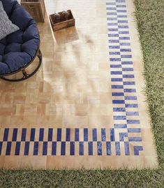 a blue couch sitting on top of a wooden floor next to a chair and table