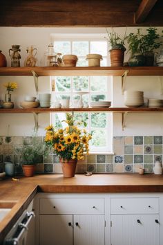 sunflowers and other flowers sit on shelves in a kitchen with tile backsplash