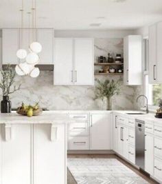 a large kitchen with white cabinets and marble counter tops, along with an area rug on the floor