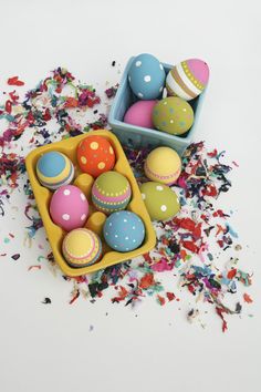 an assortment of decorated easter eggs and confetti sprinkles