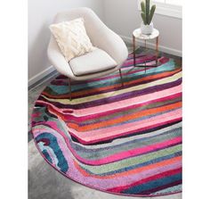 a colorful area rug with a white chair and potted cactus in the corner next to it