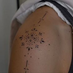 the back of a woman's shoulder with tattoos on it