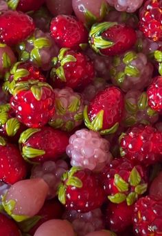 closeup of strawberries and grapes with green leaves