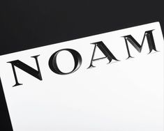 the word noam is written in black and white