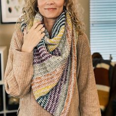 a woman wearing a multicolored knitted scarf