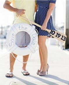 a man and woman standing next to each other holding an inflatable life preserver