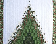 a quilted christmas tree with holly and red berries