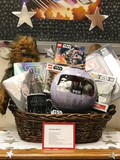 a star wars themed gift basket with toys and books on display in front of a wall