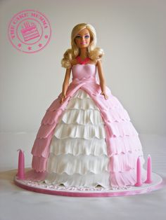 a barbie doll cake with pink and white ruffles