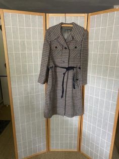 1970’s Juli de aroma houndstooth coat with a blue belt. Belt is made of a faux leather material that, being 50 years old, is now a little sticky to the touch and flakes off in the hand. Missing buttons 2 and 4 and the left pocket buttons. Bust: 40”Shoulder to hem: 41” Retro Belted Fall Outerwear, Retro Belted Outerwear For Fall, Retro Formal Fall Outerwear, Retro Winter Outerwear For Office, Retro Winter Office Outerwear, Retro Lined Outerwear For Fall, Retro Belted Outerwear For Work, Fitted Vintage Outerwear With Houndstooth Pattern, Retro Business Outerwear For Fall