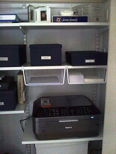 a printer, scanner and other office supplies on shelves