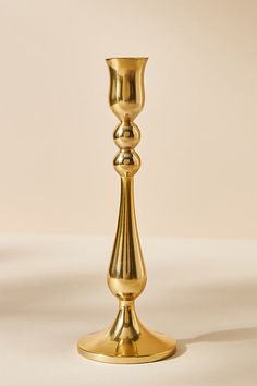 a golden candle holder on a white background