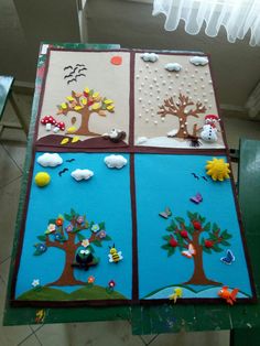 four panels with trees and birds painted on them