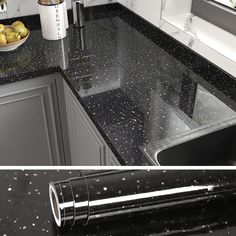 a kitchen with black counter tops and silver appliances in the back ground, and an image of a bowl of lemons on the counter top